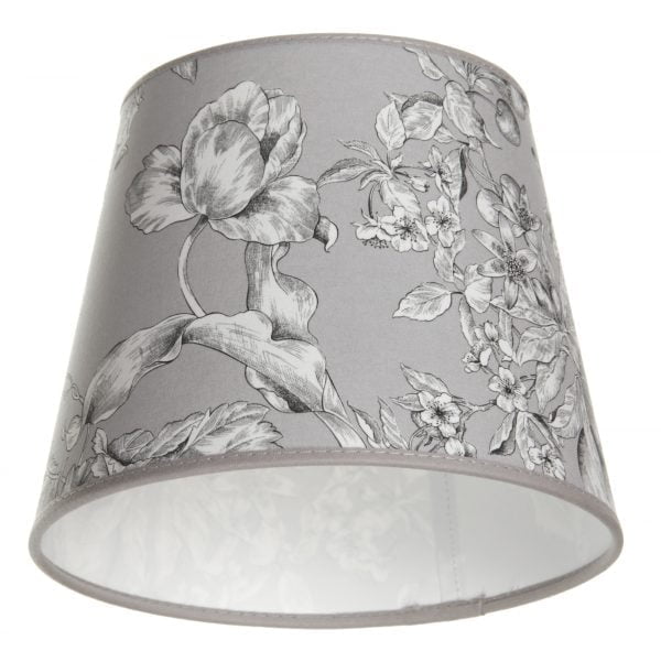 Lampunvarjostin jossa on harmaalla pohjalla kukka kuvio. Varjostin on materiaaliltaan laminoitua kangasta.